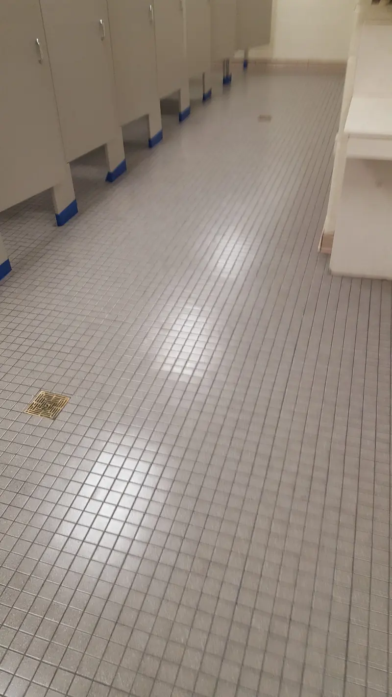 Commercial restroom with small square floor tile after cleaning