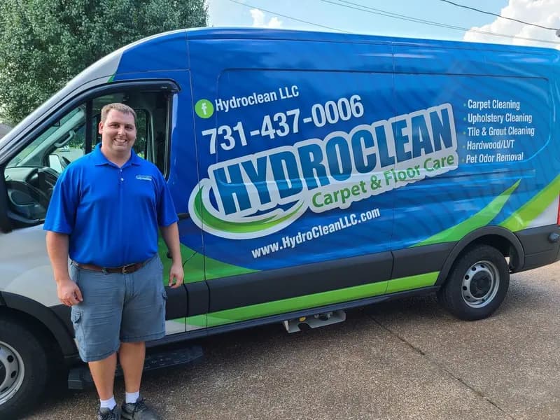 David Laton, owner of HydroClean, standing beside the company van