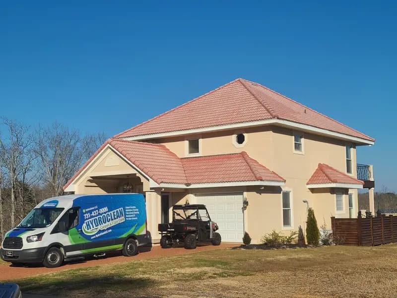 HydroClean van parked outside a two-story home