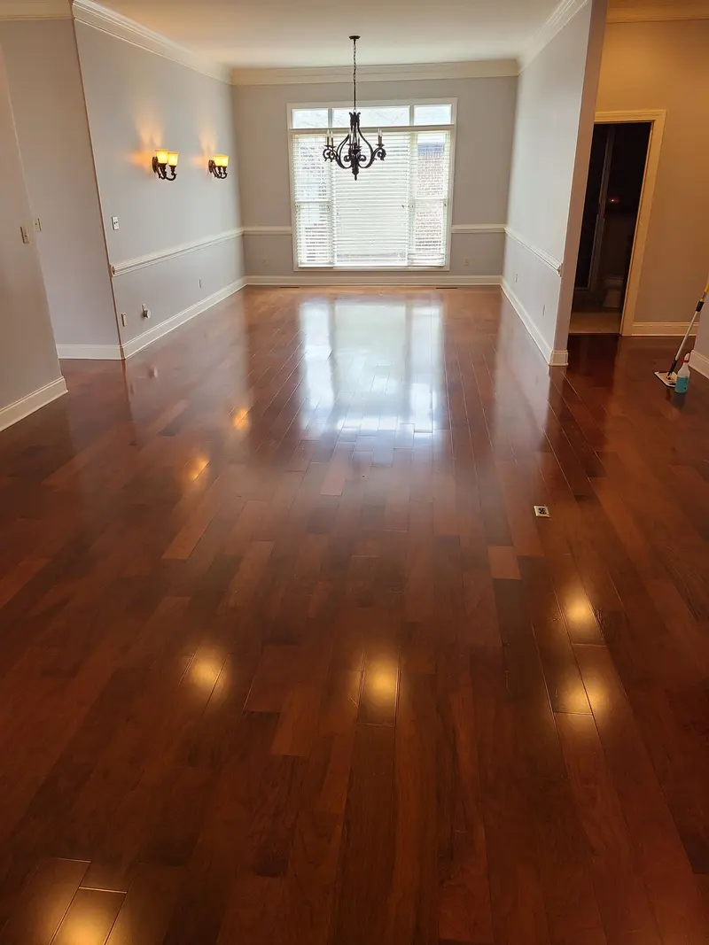 Cherry hardwood floor in an empty dining room, glossy after cleaning