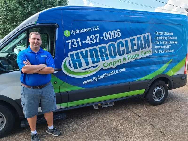 David Laton with his arms crossed in front of the HydroClean van