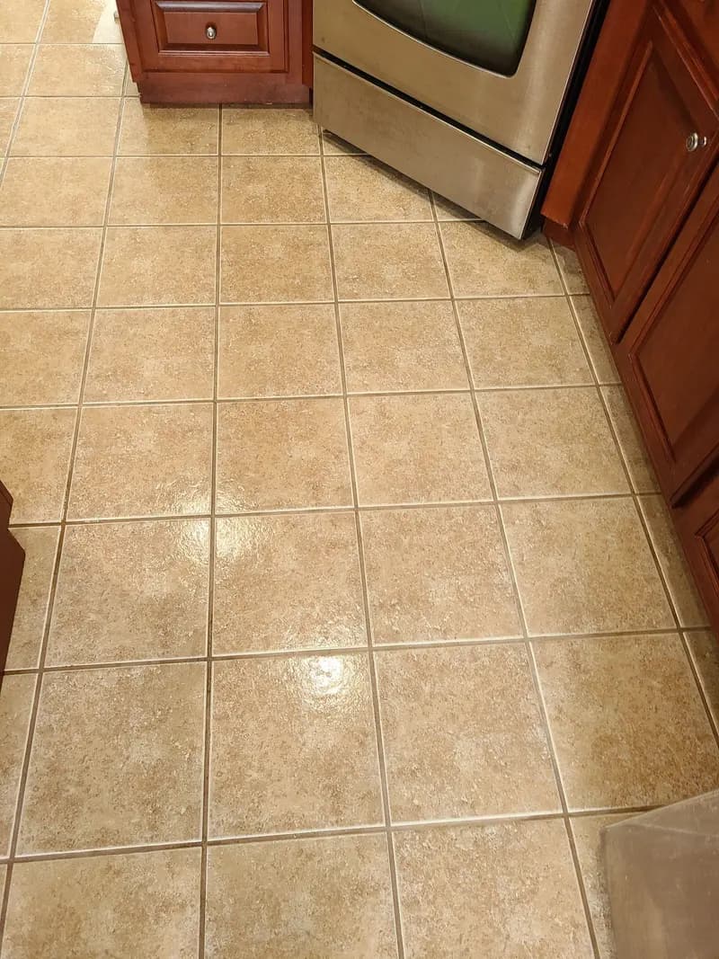 After: Kitchen tile floor with clean grout lines after cleaning