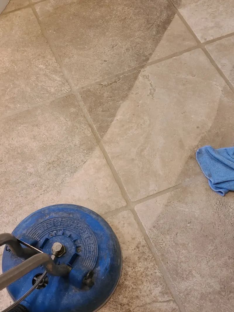 Spinner tool on a stone-look tile floor, leaving a lighter cleaned path