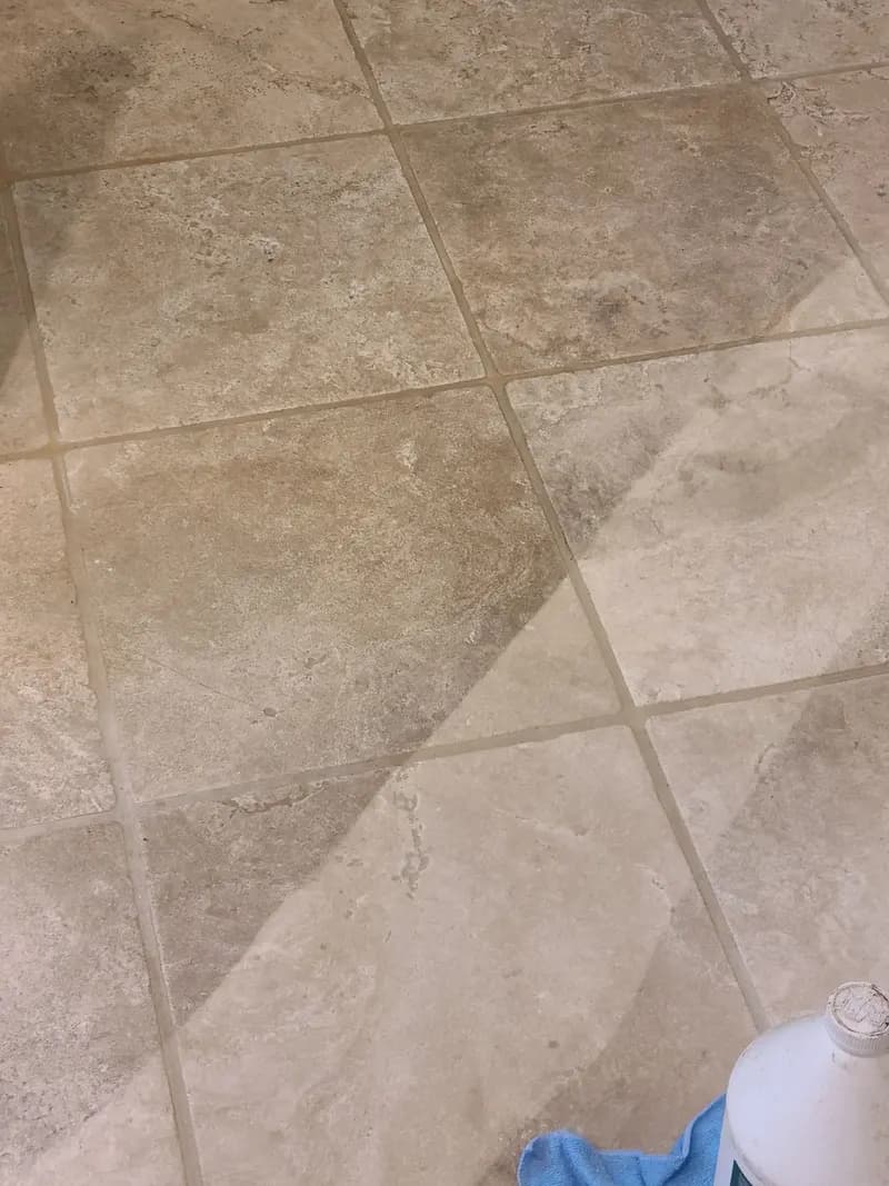 Stone-look tile floor with a diagonal line between the cleaned and uncleaned sections