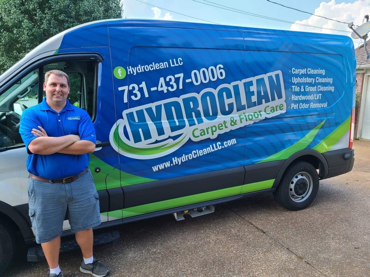 David Laton with his arms crossed in front of the HydroClean van