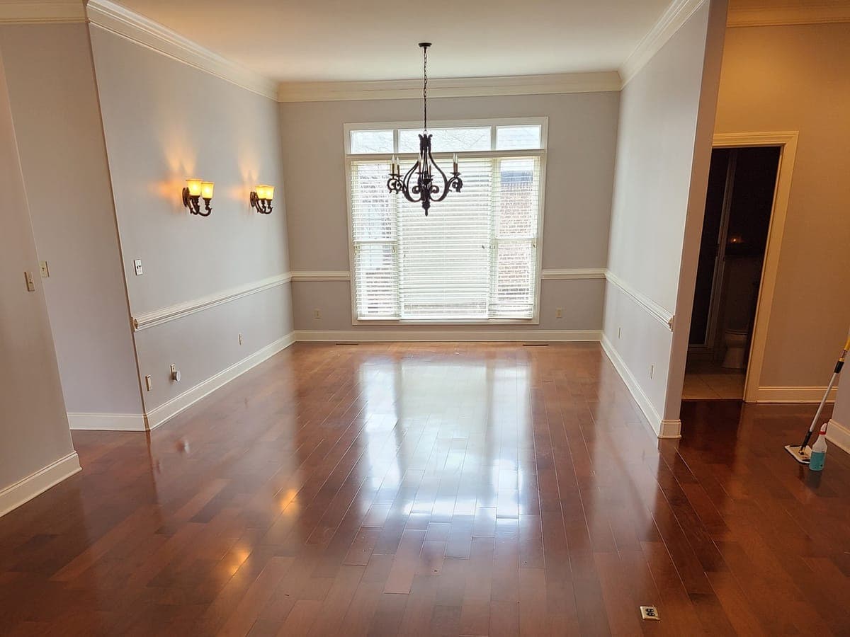 Cherry hardwood floor in an empty dining room, glossy after cleaning