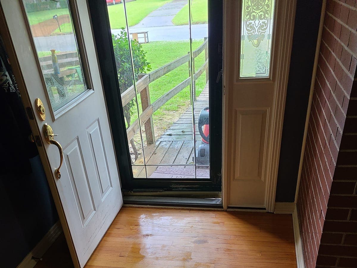 Oak hardwood floor at an open front door after a deep clean