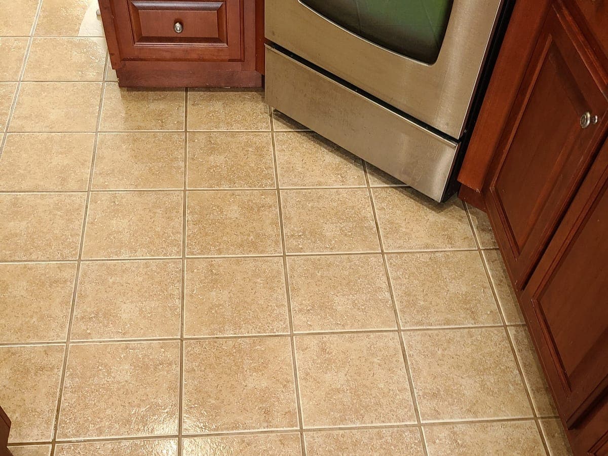 Kitchen tile floor with clean grout lines after cleaning
